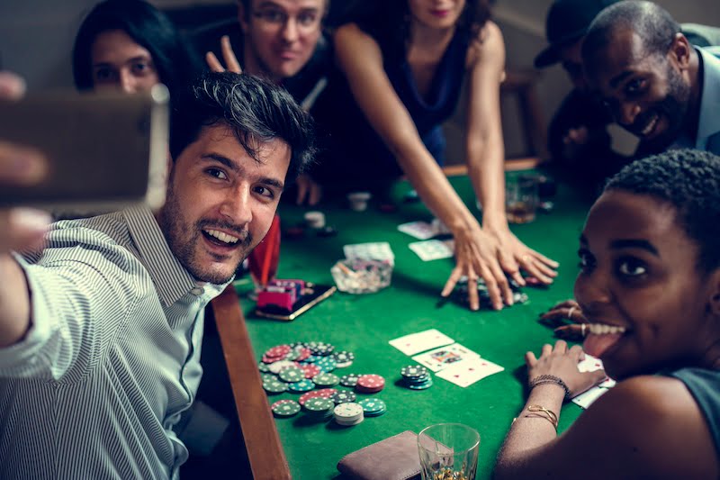 Friends playing online casino games and taking pictures